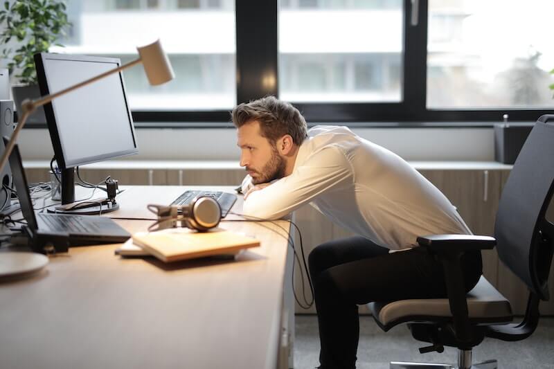man frustrated one laptop at desk