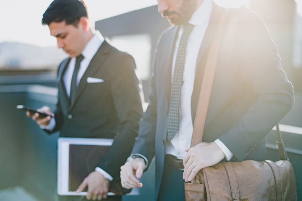 two tax consultants in suits walking two tax consultants in suits walking