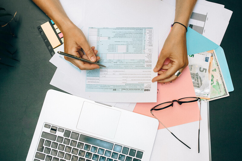 woman filling in tax declaration 1040 form